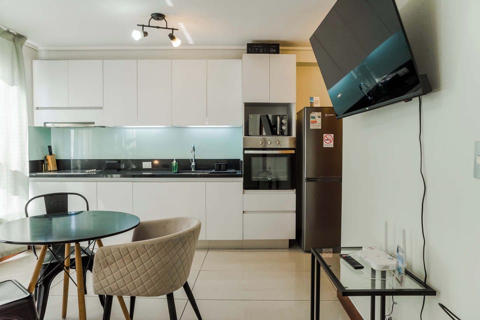 Chic and modern kitchen with dining area, perfect for cozy meals in your private studio apartment.