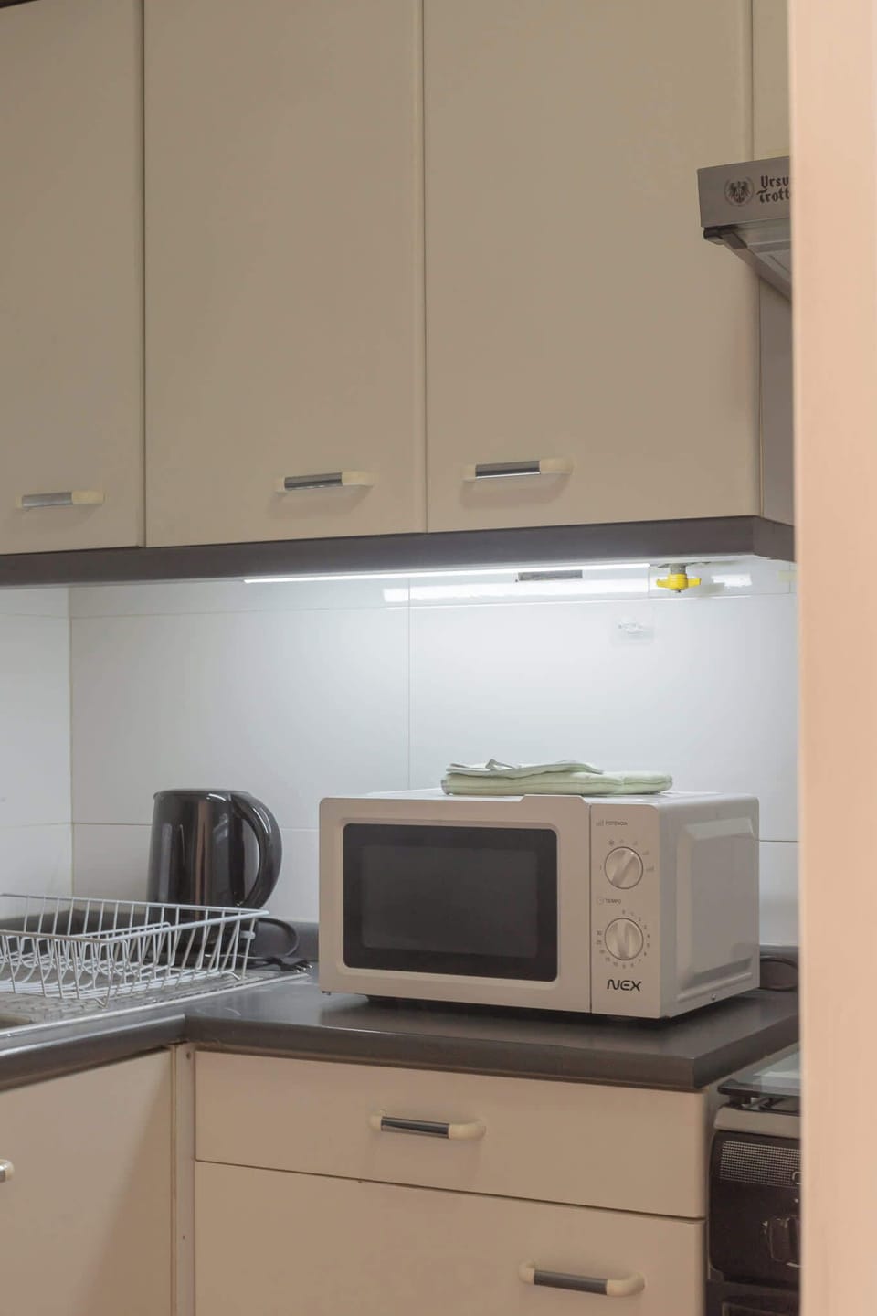 Compact kitchen with essential appliances, perfect for preparing quick meals during your stay.