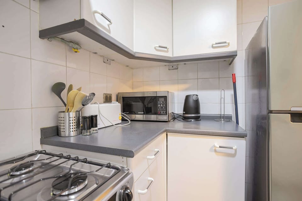 Efficient kitchen with modern appliances, perfect for preparing meals during your stay.