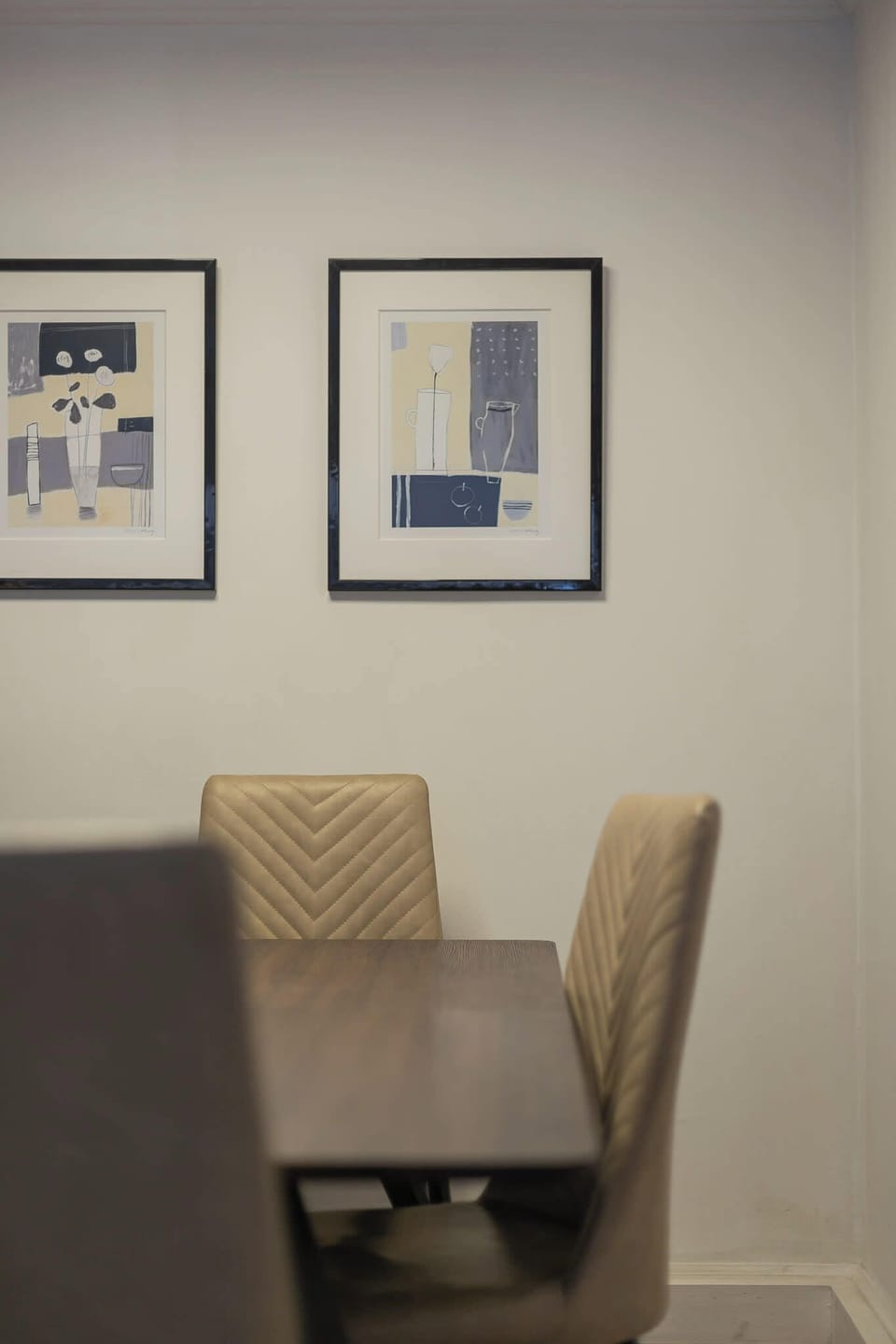 Stylish dining area with modern art and cozy seating, perfect for intimate meals.