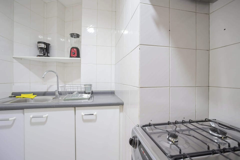 Cozy kitchen with essential appliances, perfect for preparing meals during your stay.