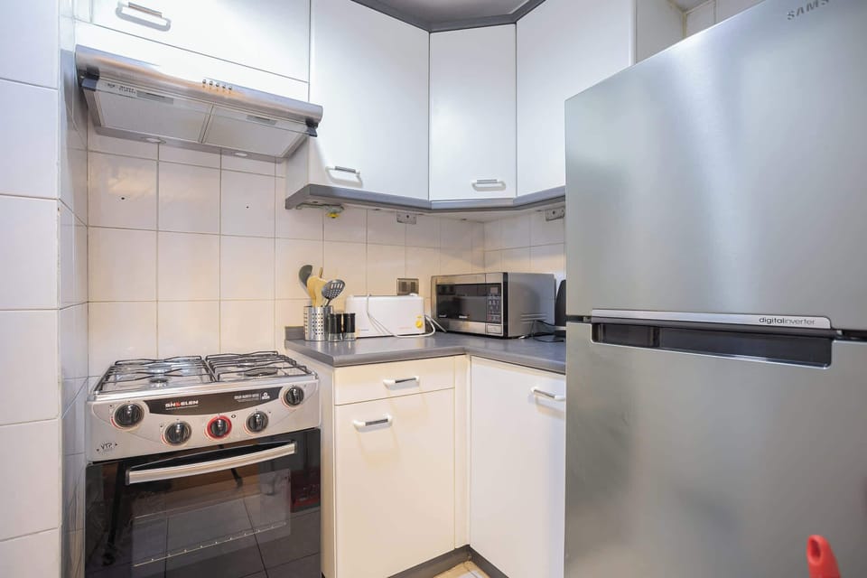 Modern and fully equipped kitchen with sleek appliances, perfect for preparing meals during your stay.