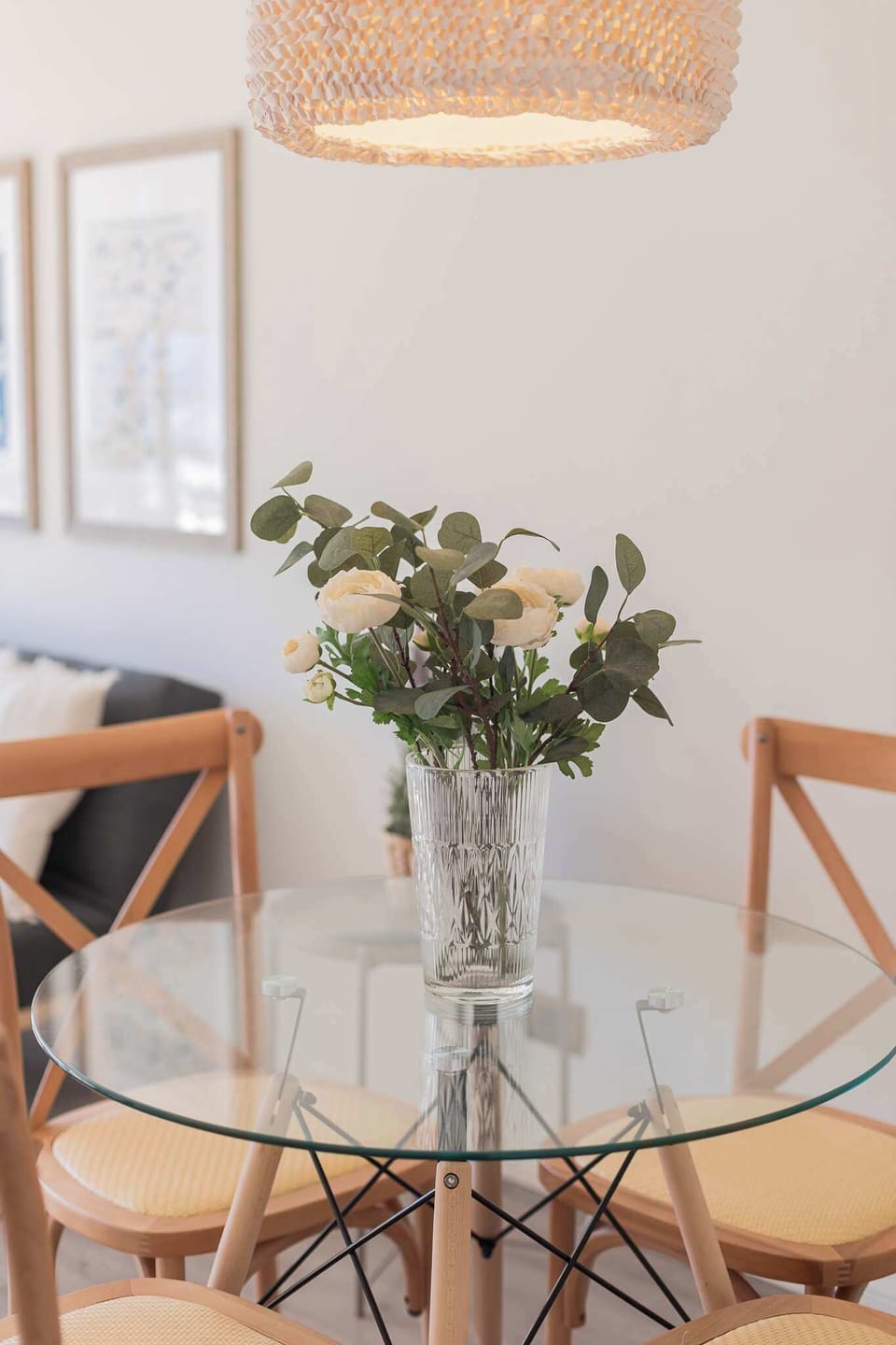 Charming dining area with a glass table and elegant decor, ideal for cozy meals and relaxation.