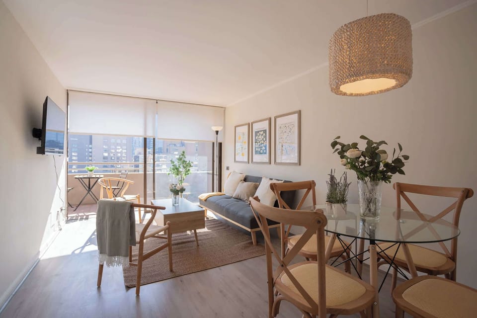 Bright and cozy living space with balcony access, perfect for relaxing and enjoying city views.