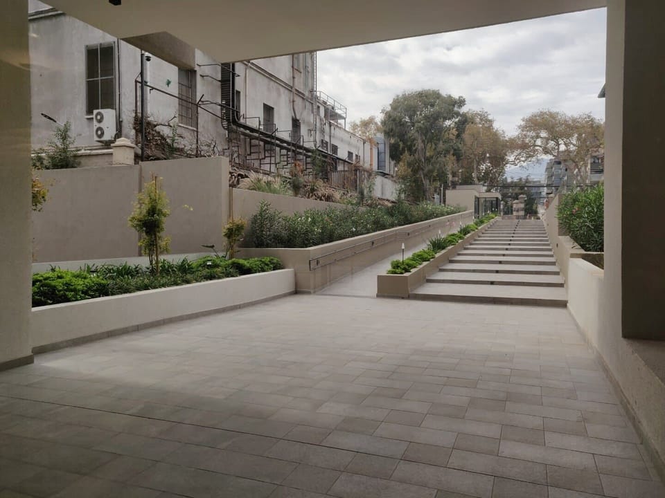 Stroll through this serene, landscaped pathway leading to your urban retreat.
