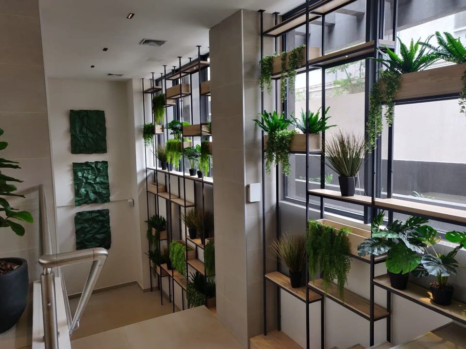 Brighten your day with this lush, plant-filled hallway, offering a refreshing and inviting atmosphere as you explore the property.