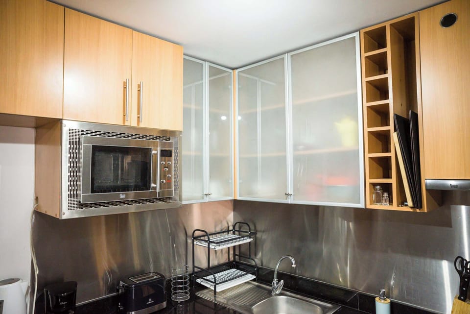 Modern kitchen with sleek cabinetry and stainless steel accents, perfect for preparing meals during your stay.