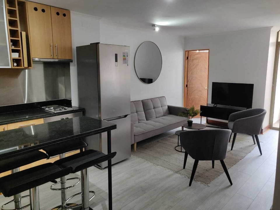 Chic and cozy living area with modern kitchen, perfect for relaxation and entertainment.