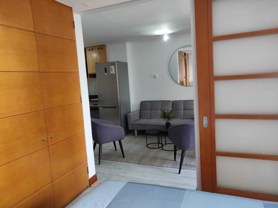 Relax in this stylish living area with modern decor and natural light, perfect for unwinding after a day exploring the city.