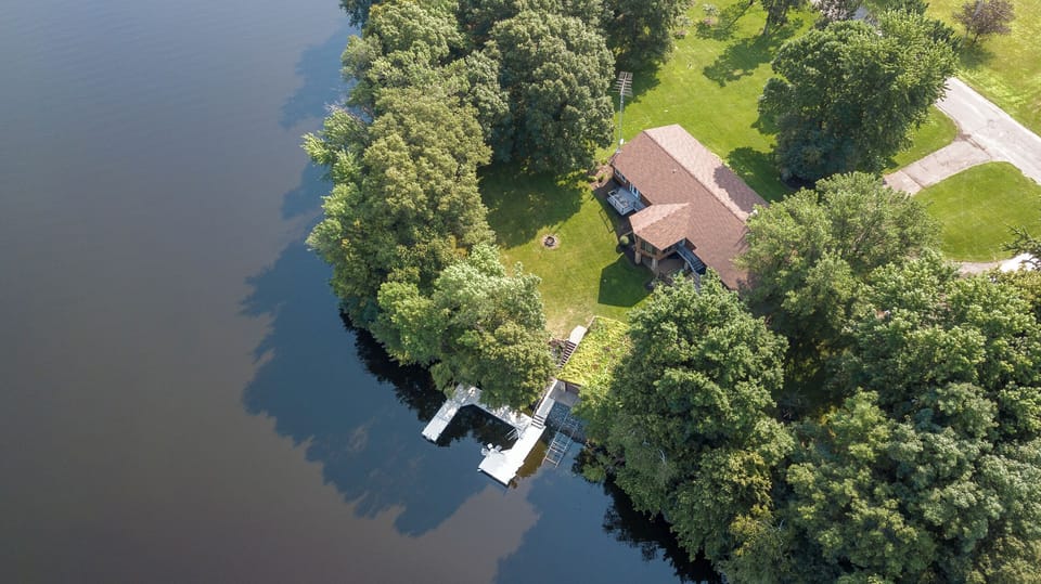 Aerial view of the house with the large dock for fishing, swimming or boat. 