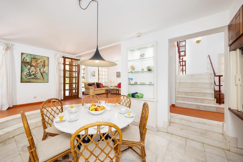 Open-plan living room with sofas, dining area, kitchen, ornamental fireplace, WiFi internet, and satellite TV