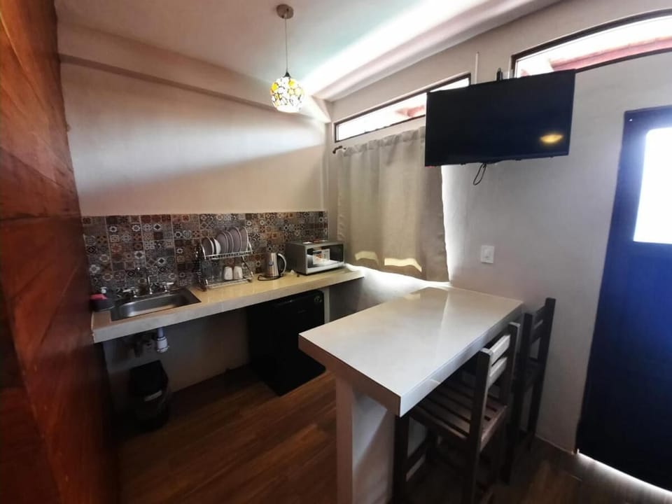 Mini-fridge, microwave, cookware/dishes/utensils, cleaning supplies