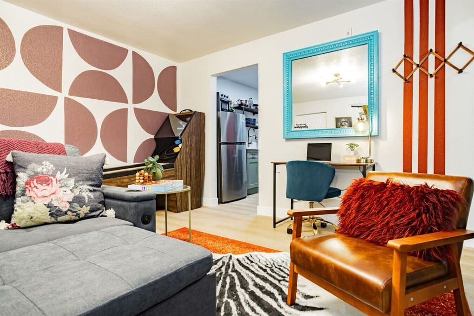 Chic Retreat: Vibrant decor, a stylish workspace, and plush seating perfect for relaxation!