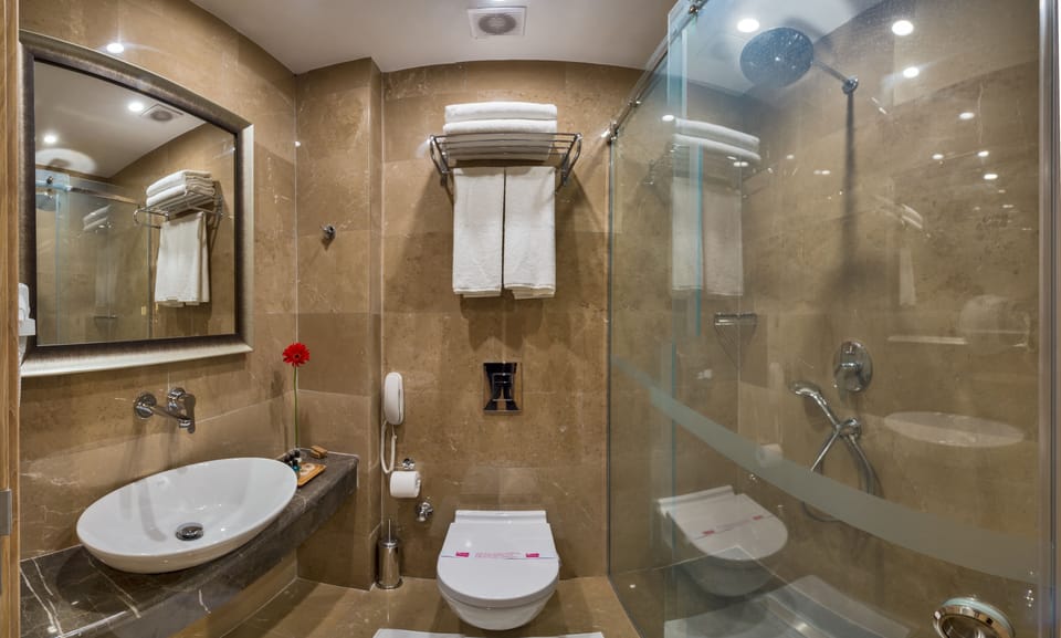 Shower, hair dryer, slippers, towels