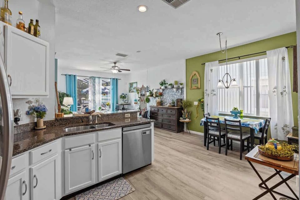 You can see being in the Kitchen does not isolate the cook from the rest of the family.  There is lots of space for dining; a Table in the Kitchen, a Bar over the sink, and the Café Table in the back corner.  There is more seating in the Dining Room.