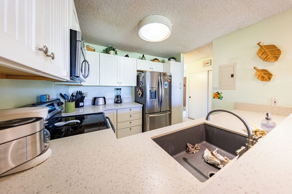 Well-equipped kitchen with island and stainless steel appliances