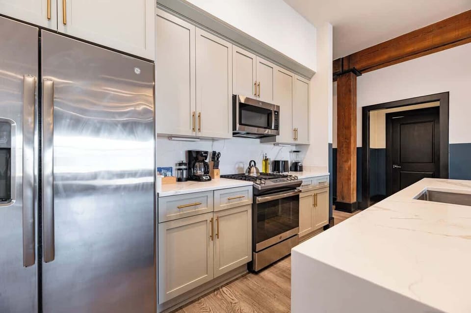 Cook or snack in style with a full kitchen featuring GE stainless appliances, cookware, and an island with bar seating. Ideal for short or extended stays, our kitchens make group travel in New Orleans easy and comfortable.