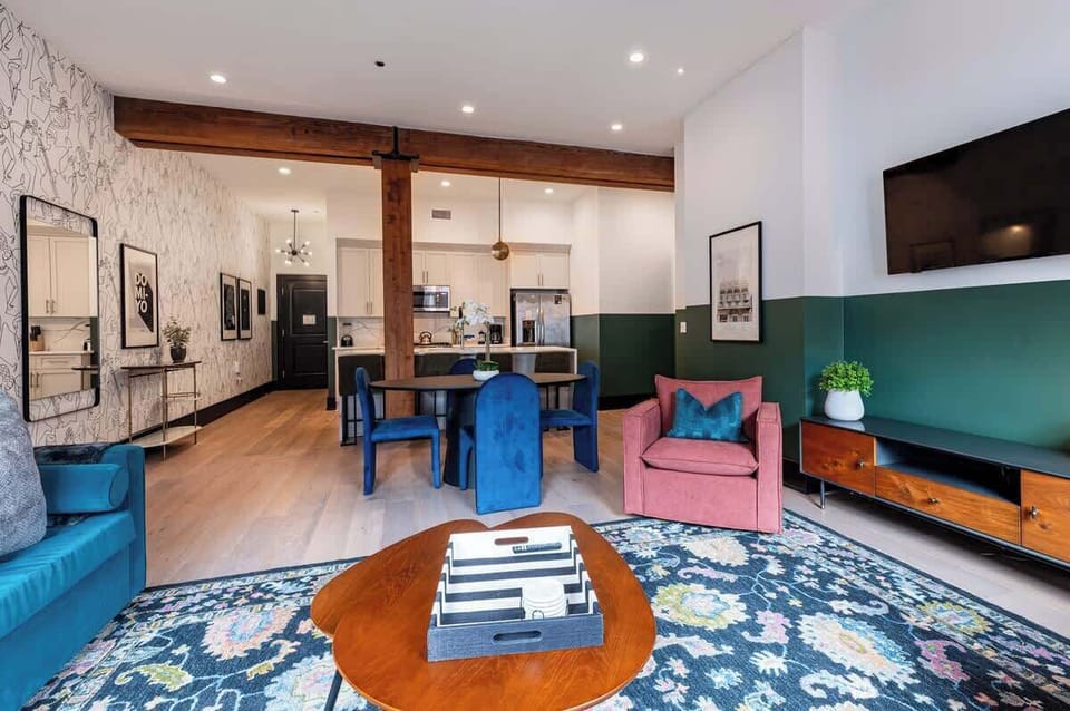 Relax in the living area with a smart TV, stylish seating, and a queen-sized sleeper sofa for extra guests. Perfect for families or group stays in New Orleans, this inviting space is ideal for movie nights or recharging after a day in the city.