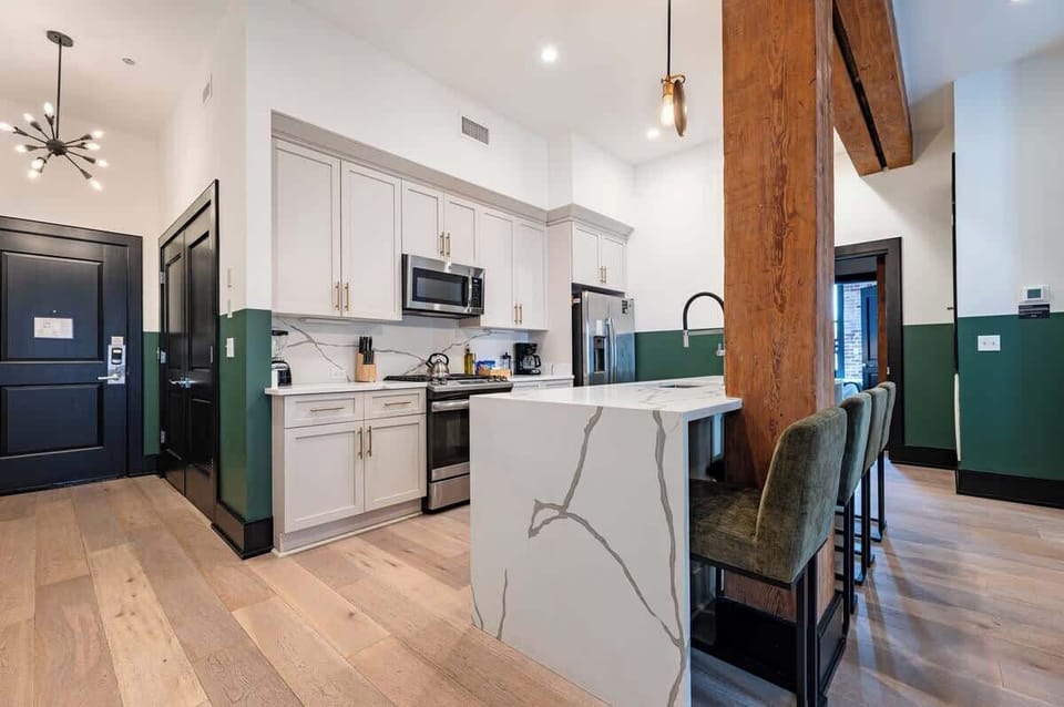 Cook or snack in style with a full kitchen featuring GE stainless appliances, cookware, and an island with bar seating. Ideal for short or extended stays, our kitchens make group travel in New Orleans easy and comfortable.