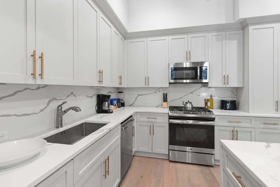 Cook or snack in style with a full kitchen featuring GE stainless appliances, cookware, and an island with bar seating. Ideal for short or extended stays, our kitchens make group travel in New Orleans easy and comfortable.