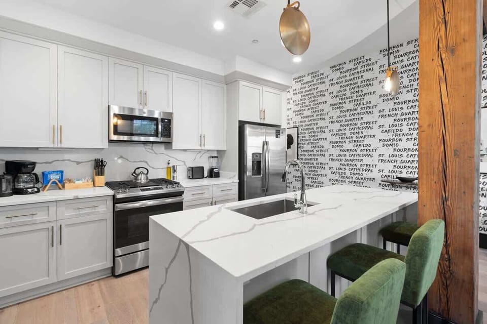 Cook or snack in style with a full kitchen featuring GE stainless appliances, cookware, and an island with bar seating. Ideal for short or extended stays, our kitchens make group travel in New Orleans easy and comfortable.