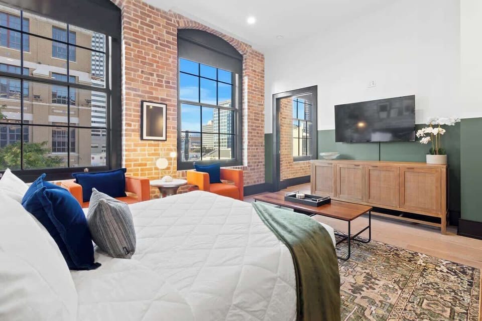 Relax in the living area with a smart TV, stylish seating, and a sleeper sofa for extra guests. Perfect for families or group stays in New Orleans, this inviting space is ideal for movie nights or recharging after a day in the city.