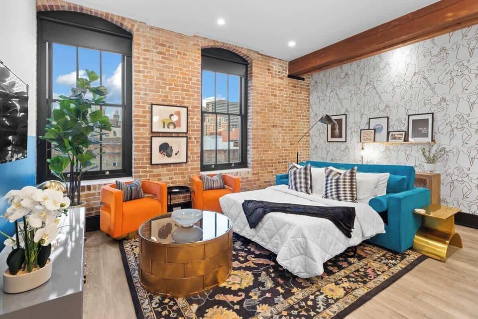 Relax in the living area with a smart TV, stylish seating, and a sleeper sofa for extra guests. Perfect for families or group stays in New Orleans, this inviting space is ideal for movie nights or recharging after a day in the city.