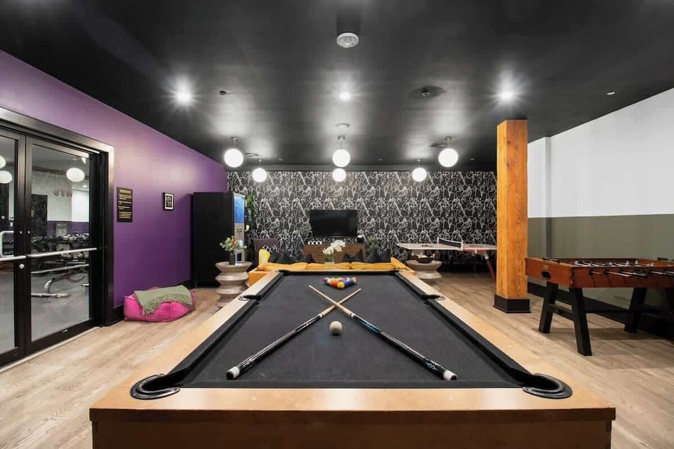 Enjoy friendly competition in 888 Baronne’s guest-only game room with a pool table, ping pong, foosball, smart TV, and sofa lounge seating. Perfect for relaxing after a day in New Orleans—ideal for families, friends, and group getaways.