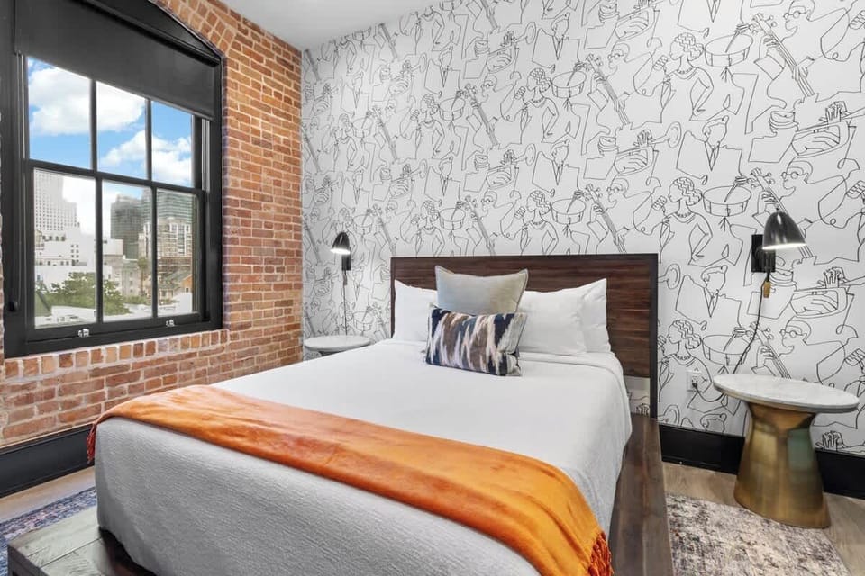 The second bedroom offers a cozy queen bed, dresser, smart TV, and soft linens. Great for families or friends traveling together, this room combines comfort and privacy in the heart of Downtown New Orleans.