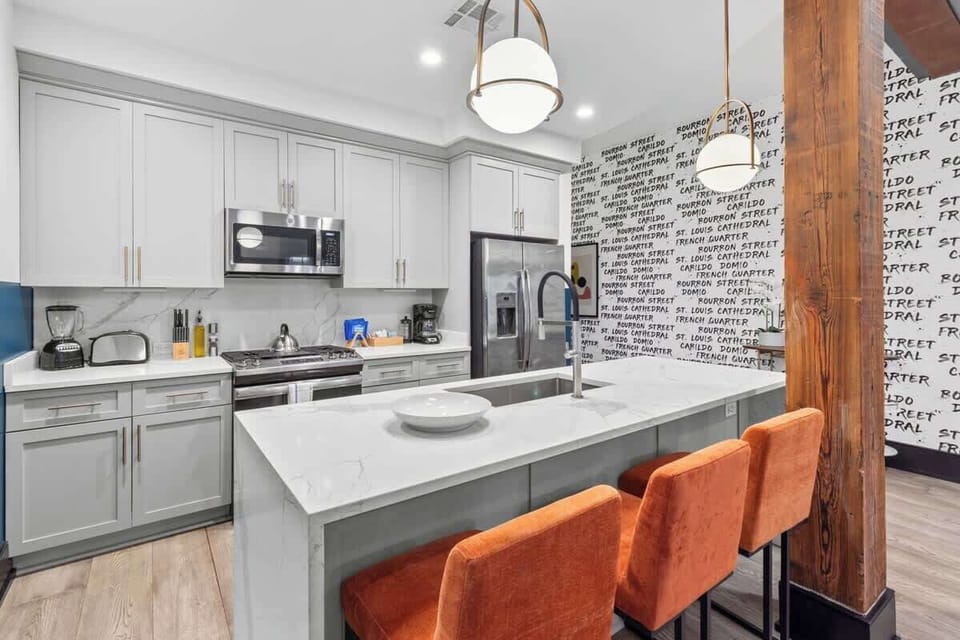 Cook or snack in style with a full kitchen featuring GE stainless appliances, cookware, and an island with bar seating. Ideal for short or extended stays, our kitchens make group travel in New Orleans easy and comfortable.