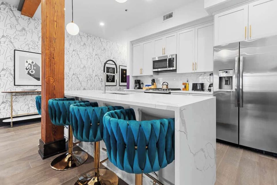 Cook or snack in style with a full kitchen featuring GE stainless appliances, cookware, and an island with bar seating. Ideal for short or extended stays, our kitchens make group travel in New Orleans easy and comfortable.