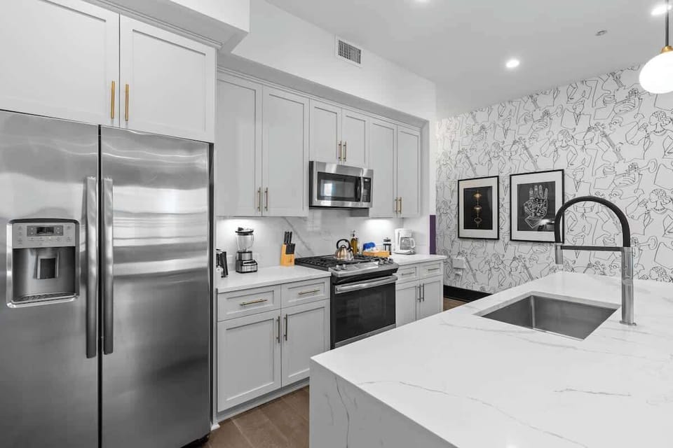 Cook or snack in style with a full kitchen featuring GE stainless appliances, cookware, and an island with bar seating. Ideal for short or extended stays, our kitchens make group travel in New Orleans easy and comfortable.