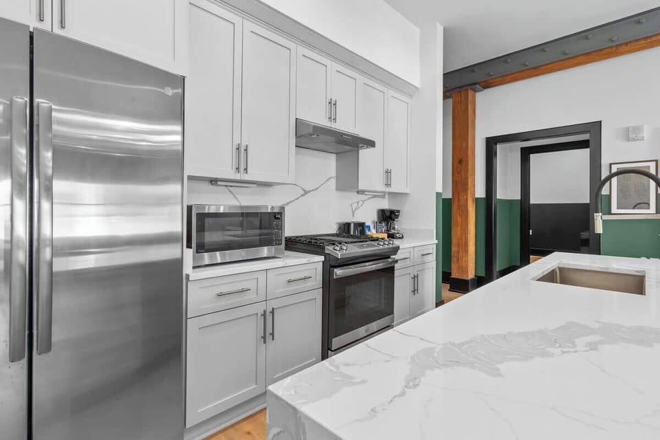 Cook or snack in style with a full kitchen featuring GE stainless appliances, cookware, and an island with bar seating. Ideal for short or extended stays, our kitchens make group travel in New Orleans easy and comfortable.