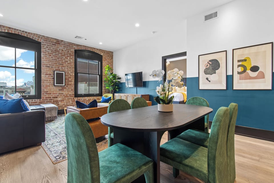 Enjoy meals together at your in-suite dining table with seating for your group. Whether it's takeout, delivery, or a home-cooked meal, this cozy dining area makes every stay at 888 Baronne feel like home in New Orleans.