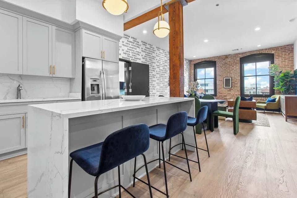 Cook or snack in style with a full kitchen featuring GE stainless appliances, cookware, and an island with bar seating. Ideal for short or extended stays, our kitchens make group travel in New Orleans easy and comfortable.