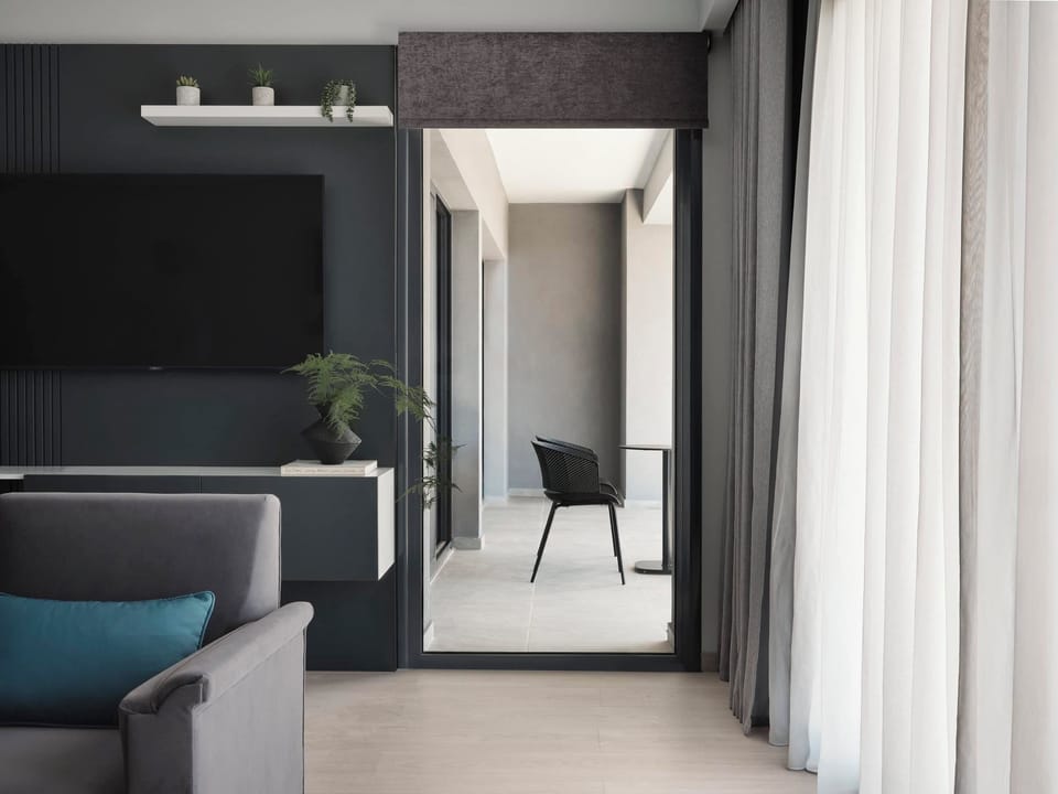 Family Suite, Balcony, City View | Living area | 40-inch Smart TV with cable channels, DVD player