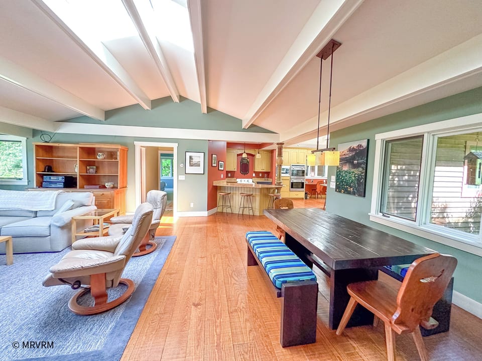 Living room opens to dining and kitchen areas
