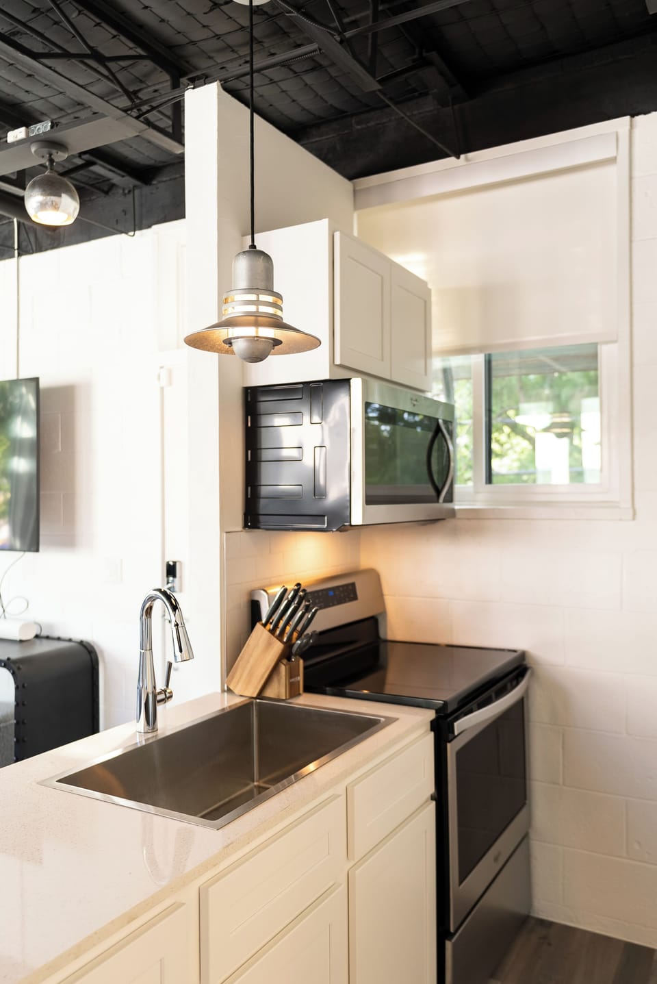 Bright kitchen space with essential appliances.