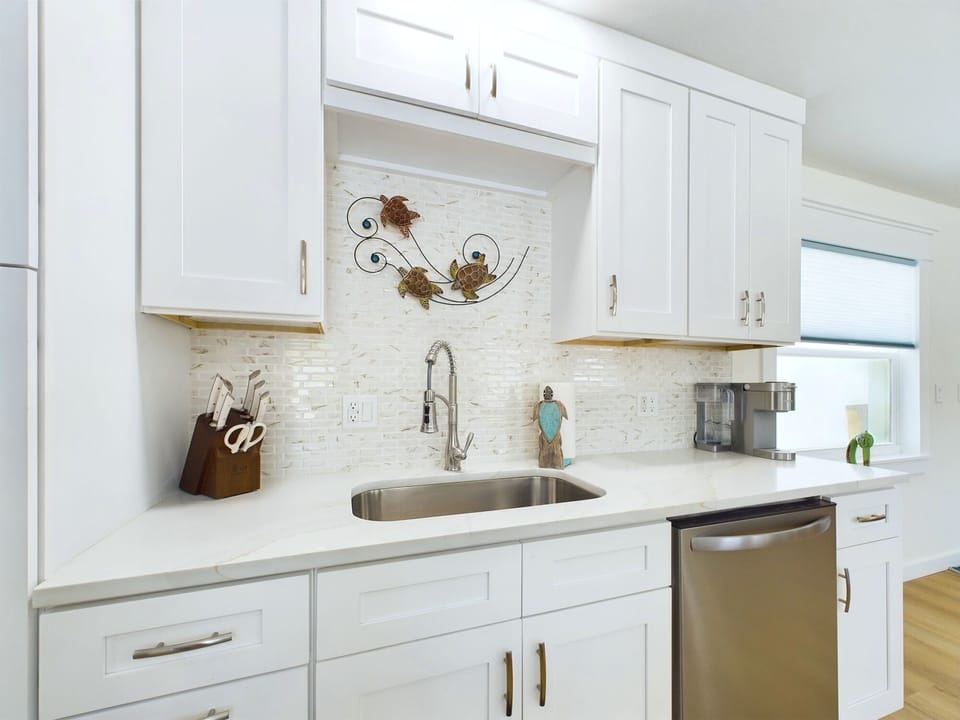 Pearl accents, quartz countertops, and stainless steel appliances
