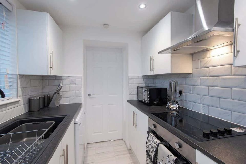 This kitchen space is  bathed in light that enhances its inviting ambiance. Safety is ensured with well-placed countertops and easy-to-reach cabinets.