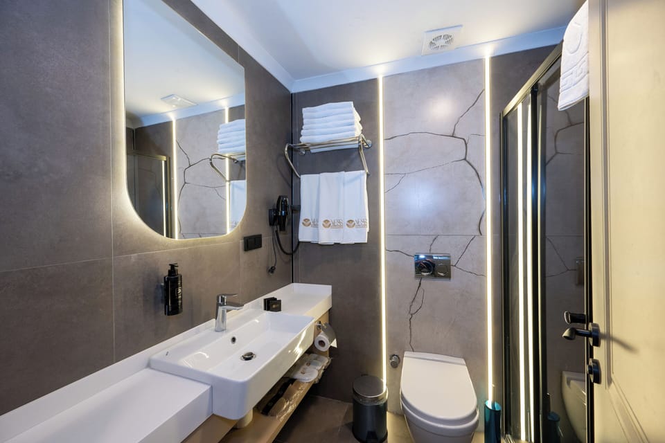 Shower, hair dryer, slippers, towels