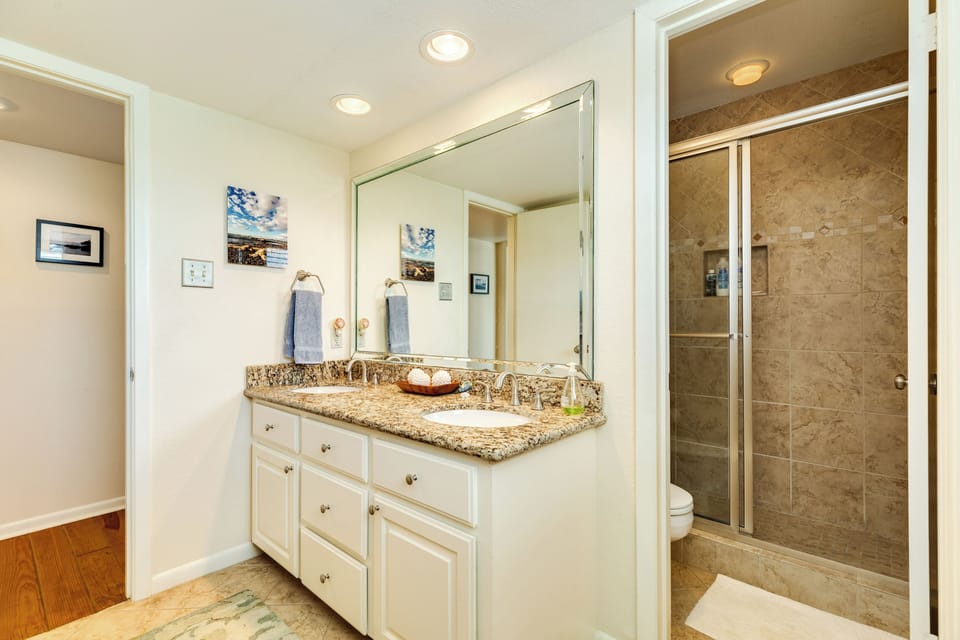 Main level bathroom with double vanity & walk-in shower