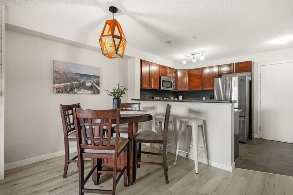 Dining area with table seating for 4 and 2 on the island.