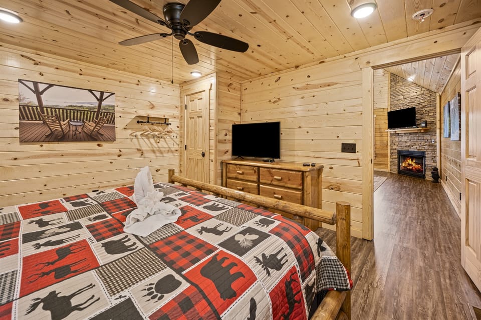 King sized bed on the main level with a smart tv.