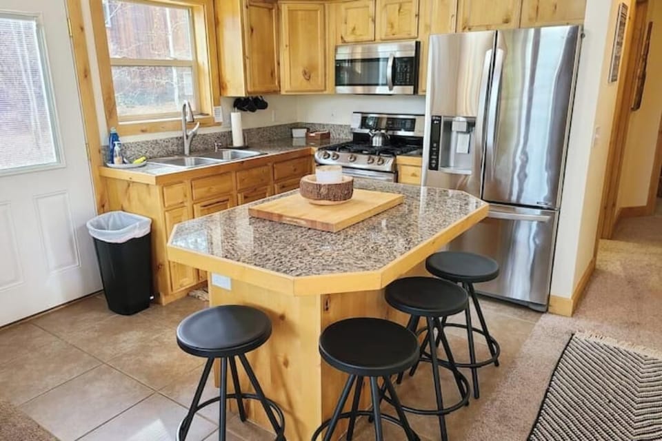 Kitchen with new stainless steel appliances and gas stove.