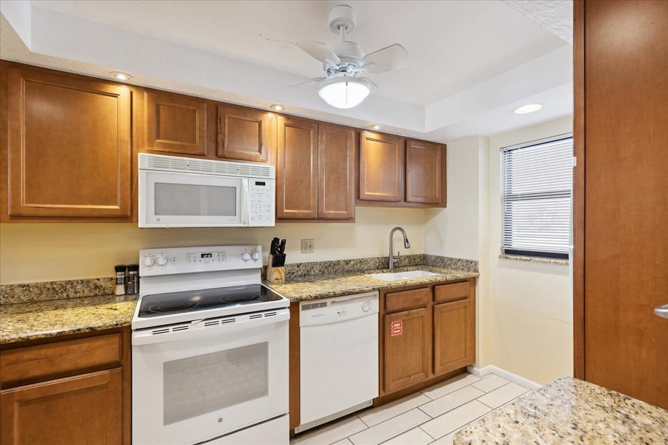 Warm and inviting kitchen with granite counters and modern appliances.