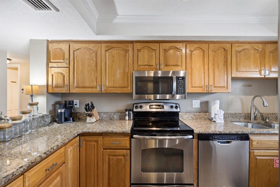Fully equipped kitchen with granite countertops and modern appliances.
