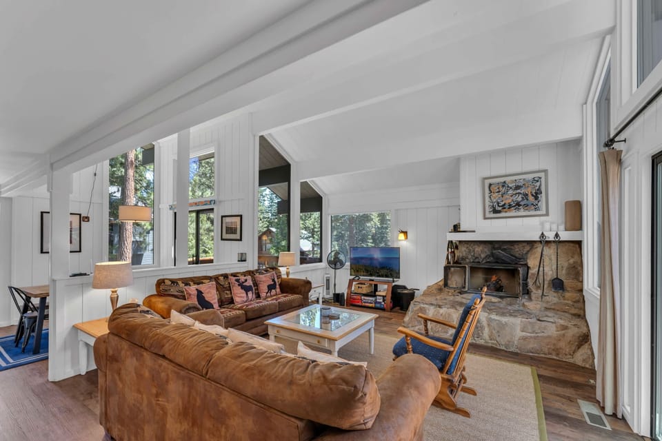 Living Room: 2 sofas, Smart TV, custom stone wood fireplace, board games, access to deck