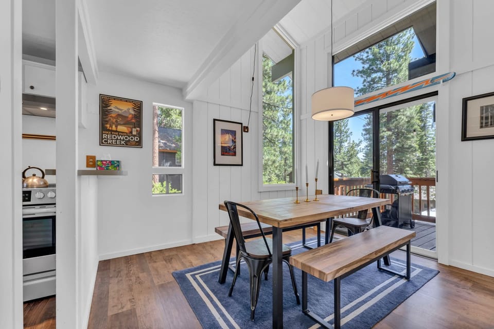 Dining Room: 6-person dining table, soaring windows, access to deck, located between the living room and kitchen
