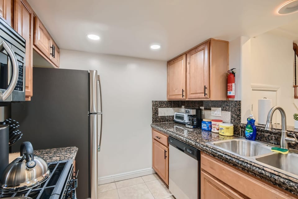 Enjoy the full kitchen with a refrigerator, freezer, oven, stove, microwave, dishwasher, coffee, creamers, mixers, spices, pots, pans, cooking supplies, cutlery, cups, plates, bowls, utensils, small appliances, and many more essentials.